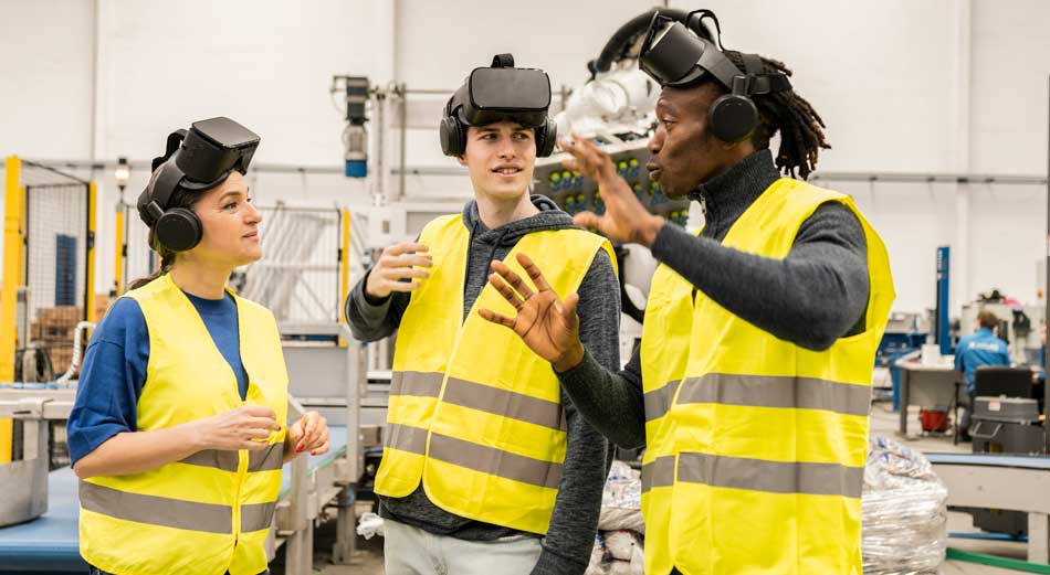 Three diverse engineers using augmented reality (AR) simulation at work