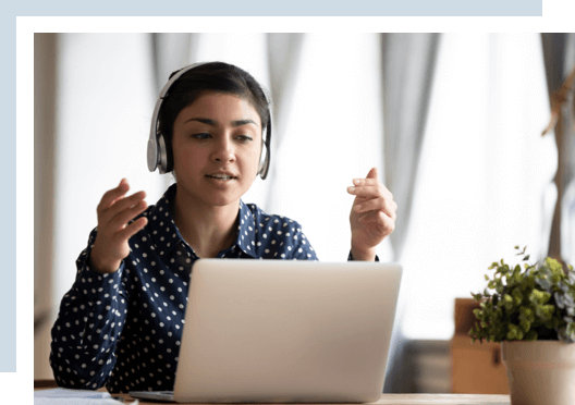 a woman student on a computer and on a video call with other students