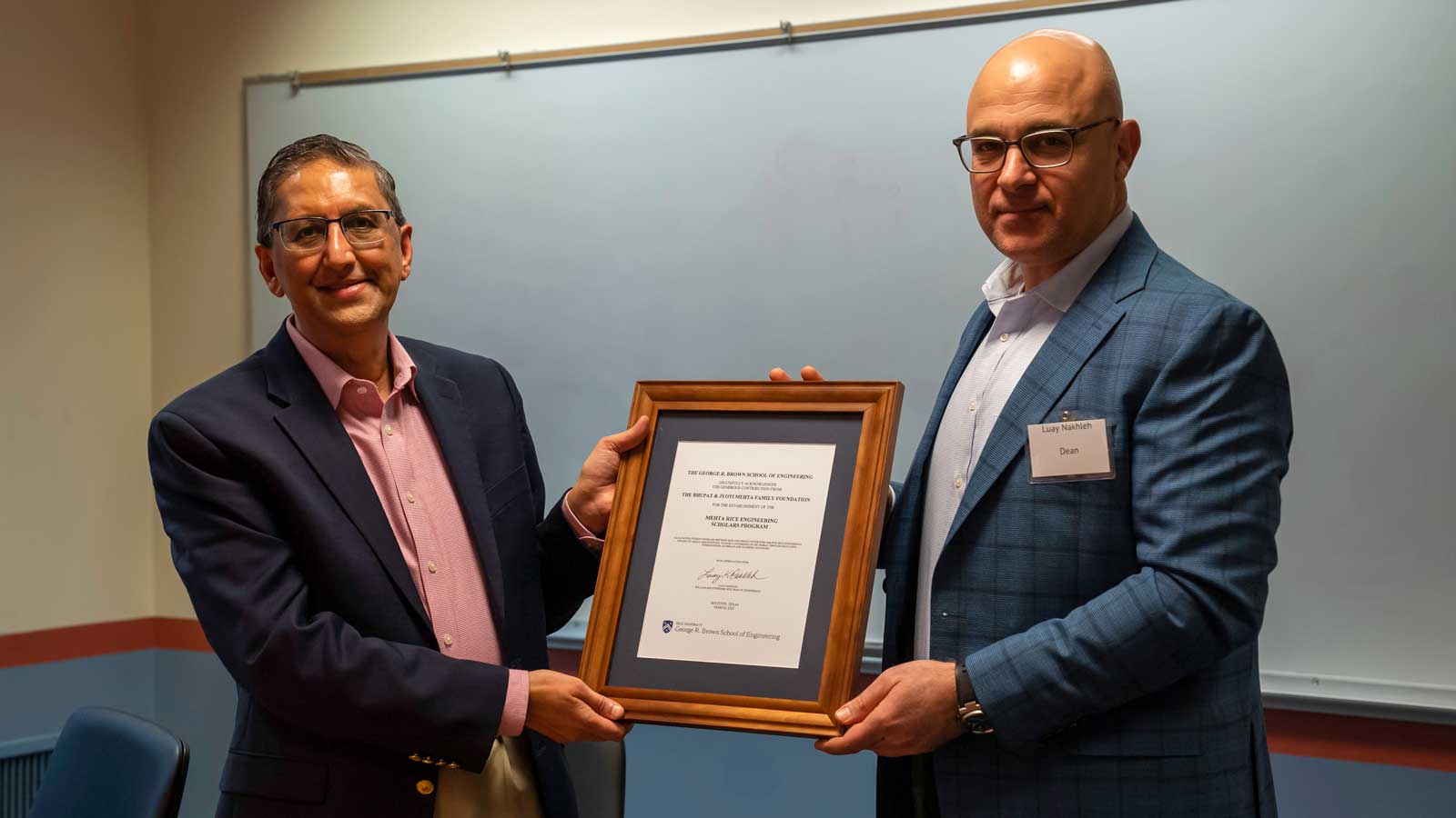 Rahul Mehta and Luah Nakhleh holding a certificate