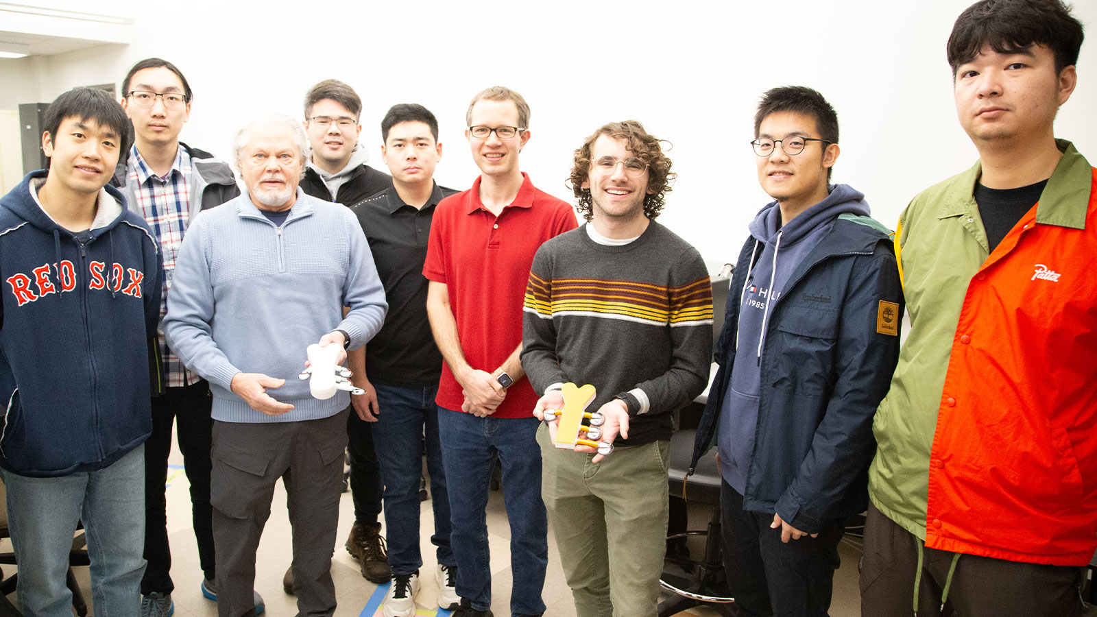 Cairdio research group poses for a photo holding the heart disease detection device
