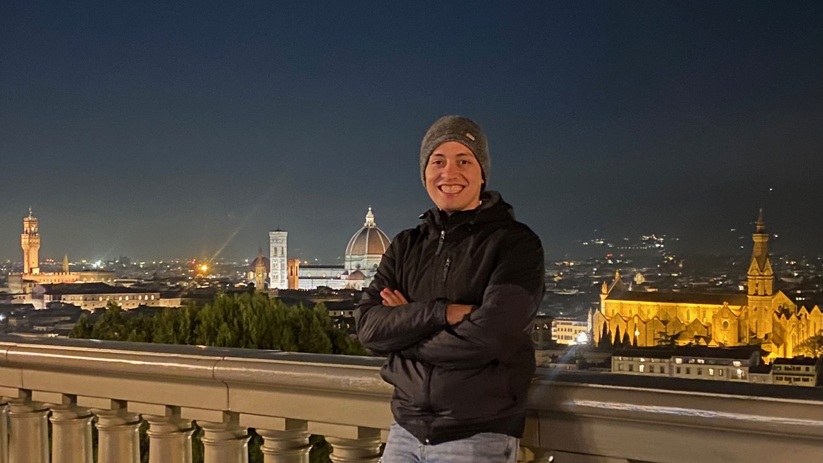 Mauro Florez stands on a balcony in Florence overlooking the Duomo and other landmarks
