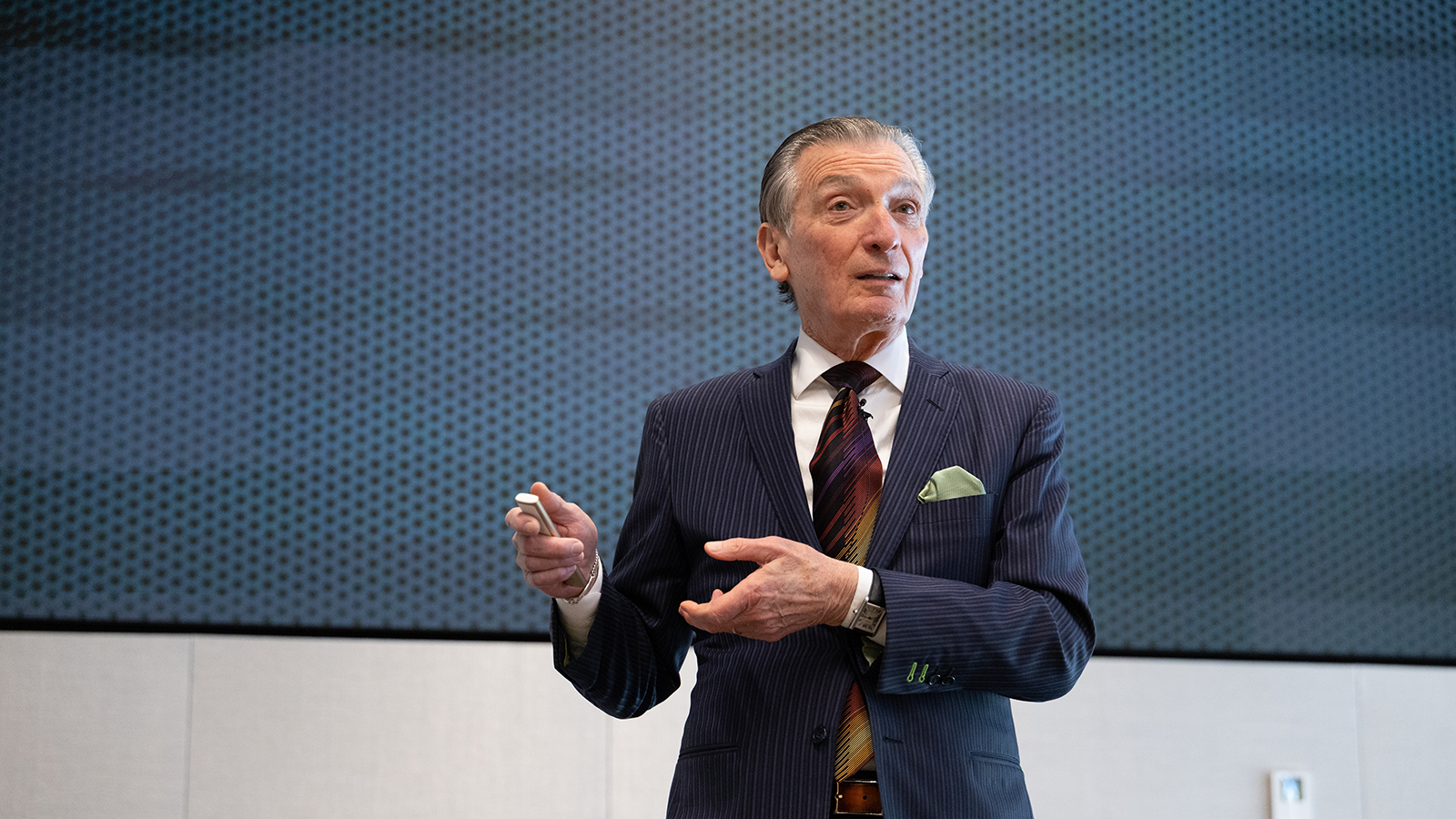 MIT Professor Emeritus Don Sadoway is animated and talking in front of a presentation.