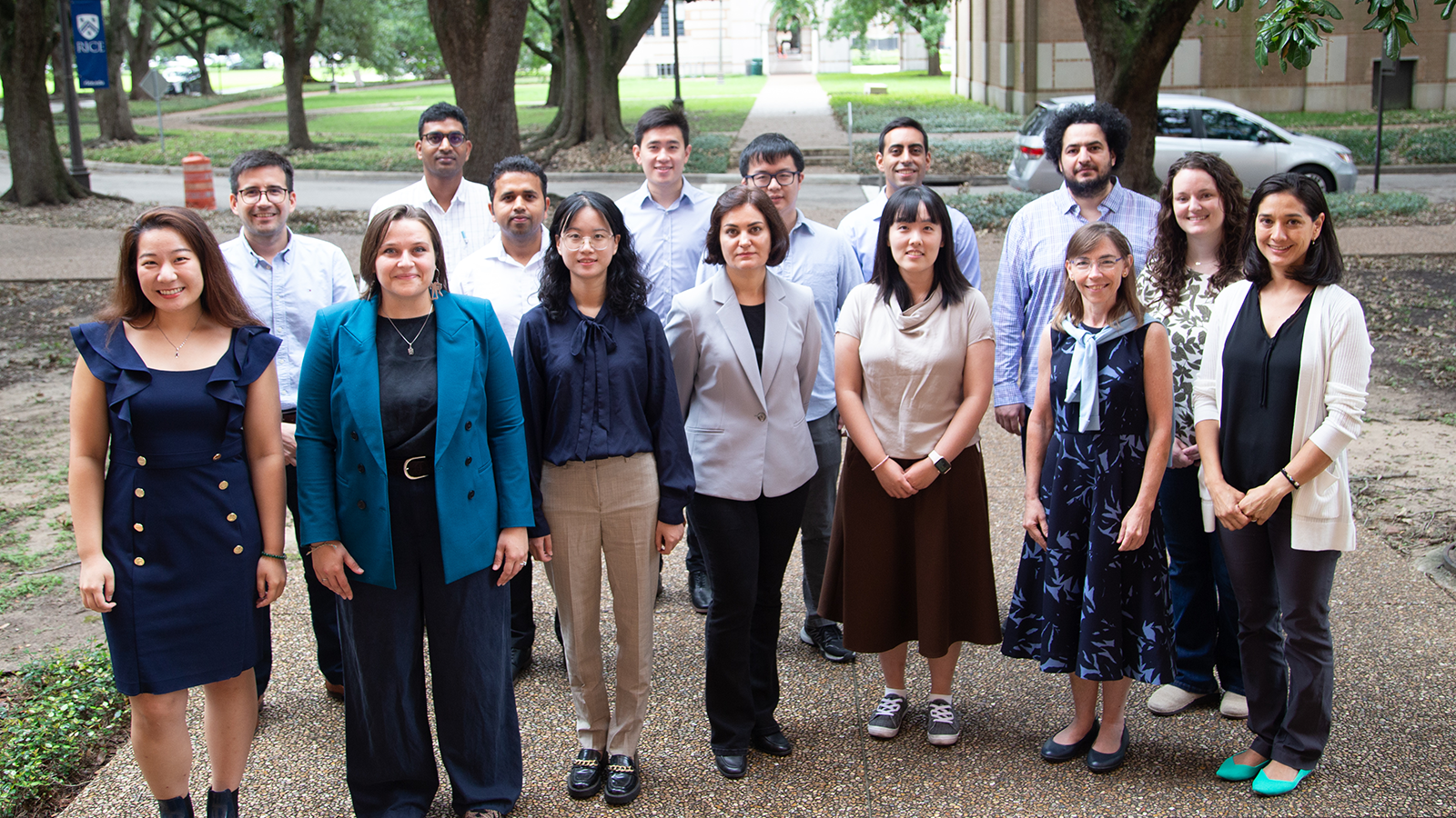 Group of 14 Future Faculty Fellows from the 2024-2025 cohort stand with Renata Ramos, Senior Associate Dean for Academic Affairs at Rice Engineering and Computing, with Rice University campus in the background.