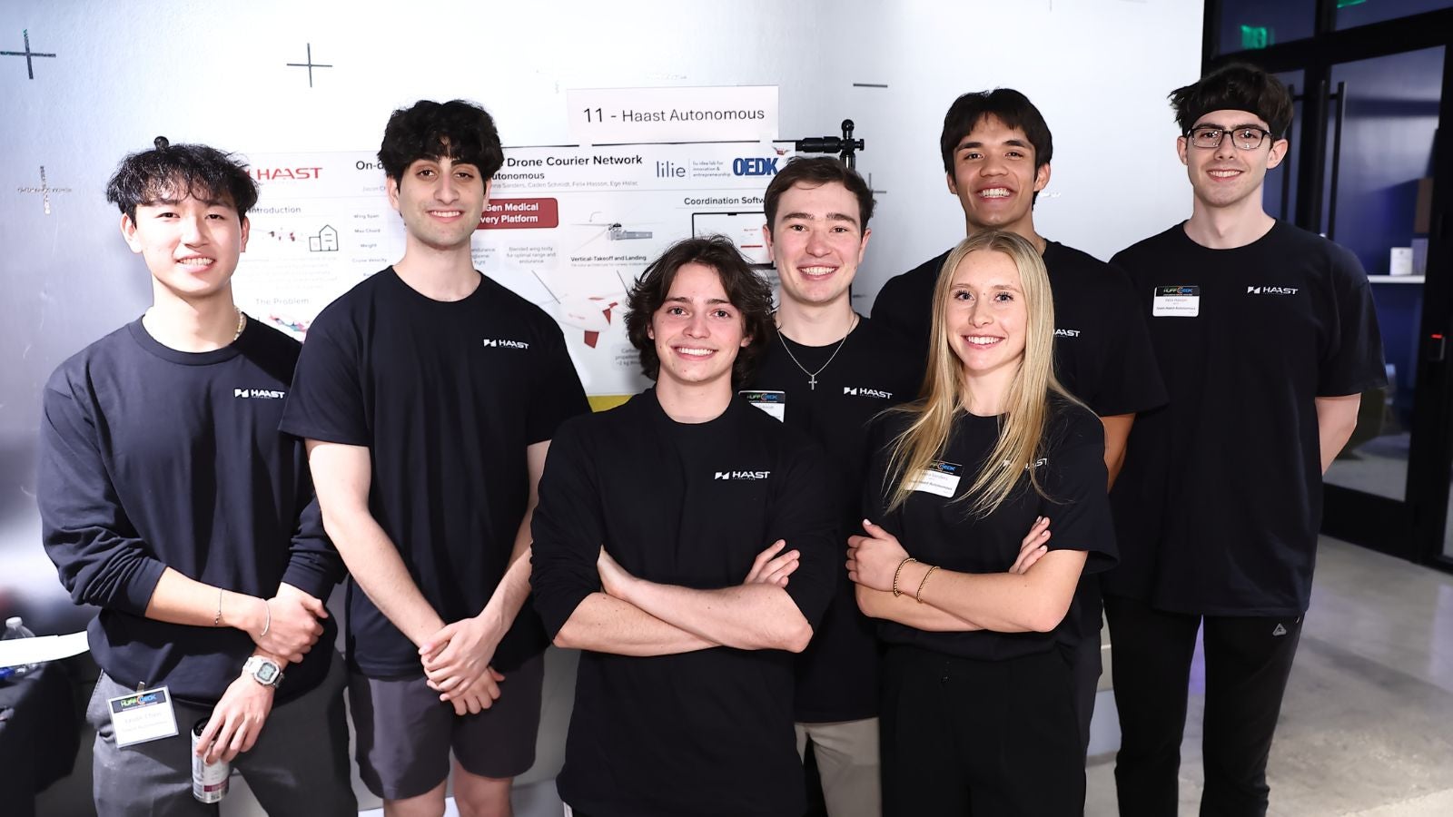 Jason Chen, Ege Halac, Santoago Brent, Caden Schmidt, Kenna Sanders, Ethan Javedan and Felix Hasson  pose by their poster at the OEDK showcase