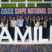 Group of students from the Society of Hispanic Professional Engineers standing behind a sign that reads "Familia."