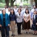 Group of 14 Future Faculty Fellows from the 2024-2025 cohort stand with Renata Ramos, Senior Associate Dean for Academic Affairs at Rice Engineering and Computing, with Rice University campus in the background.